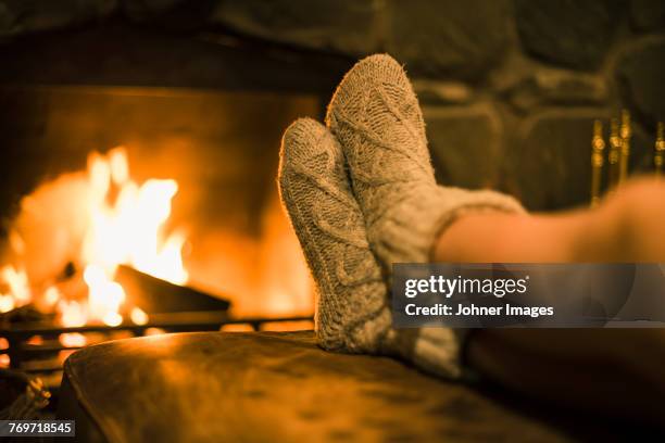 feet in wool socks near fireplace - girls with hot legs stock pictures, royalty-free photos & images