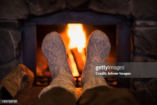 feet in wool socks near fireplace - wool stock pictures, royalty-free photos & images