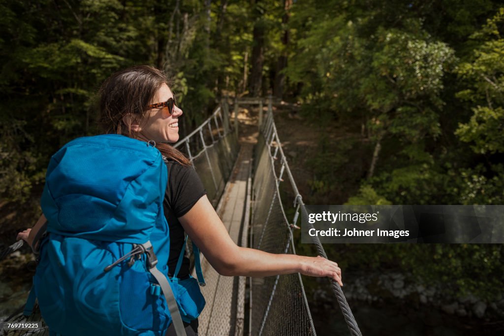 Woman walking through hanging bridge