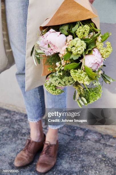 woman holding flowers - johner images bildbanksfoton och bilder