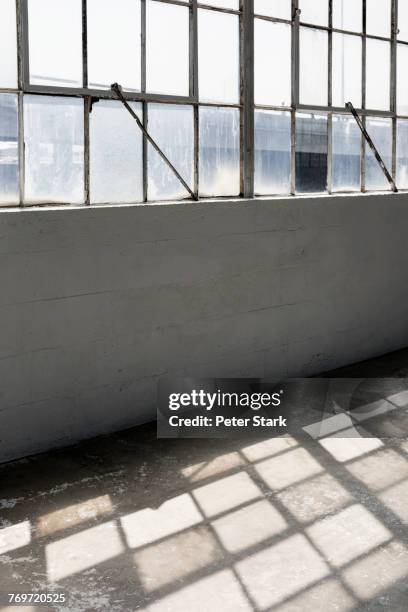 sunlight shining through windows in corridor - warehouse loft stock pictures, royalty-free photos & images
