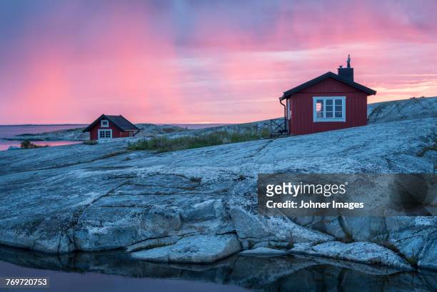 wooden house on rocky coast - schweden stock-fotos und bilder