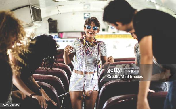 a young woman having a birthday party on a bus. - bus interior fotografías e imágenes de stock