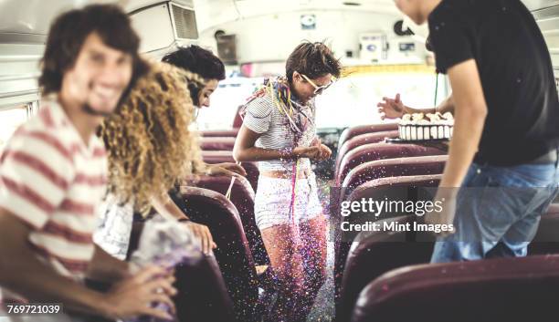 a group of young people in a party on a school bus. - birthday streamers stock-fotos und bilder