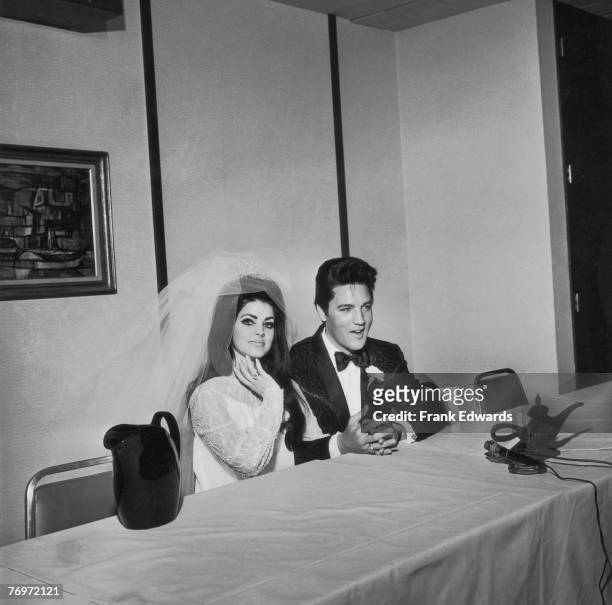 American rock n' roll singer and actor Elvis Presley with his bride Priscilla Presley on their wedding day, at the Aladdin Hotel, Las Vegas, Nevada,...