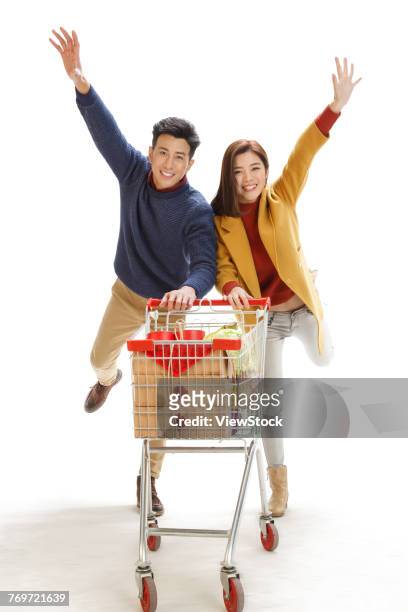 happy couple shopping - man pushing cart fun play stock pictures, royalty-free photos & images