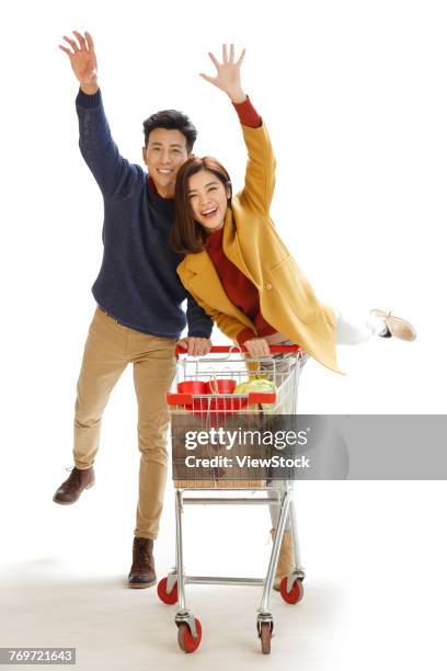 happy couple shopping - man pushing cart fun play stock pictures, royalty-free photos & images