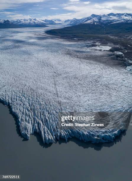 aerial view of glacier by lagoon, knik glacier, palmer, alaska, usa - knik glacier stock pictures, royalty-free photos & images