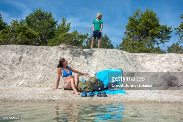 mother and son at sea - lagoon stock-fotos und bilder