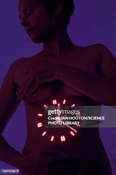 woman with clock projected on stomach - biologische uhr stock-fotos und bilder