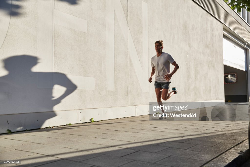 Young man running in the city