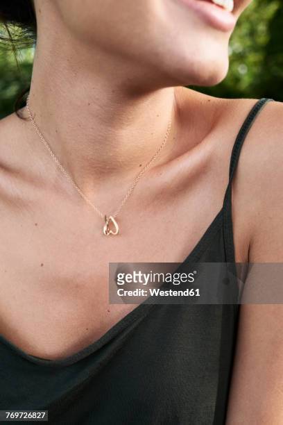 cleavage of a young wiman with a golden necklace - necklace stock-fotos und bilder