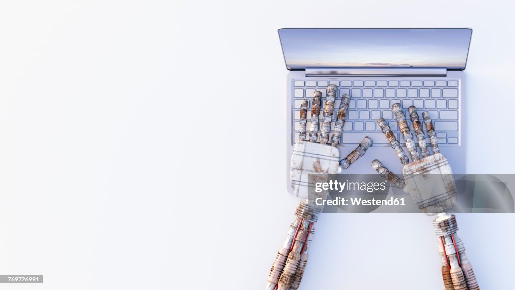 Robot hands typing on a laptop