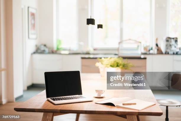 laptop and notebook on table at home - laptop table stock pictures, royalty-free photos & images