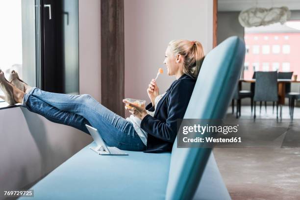 smiling businesswoman having lunch break - vinyl window stock pictures, royalty-free photos & images