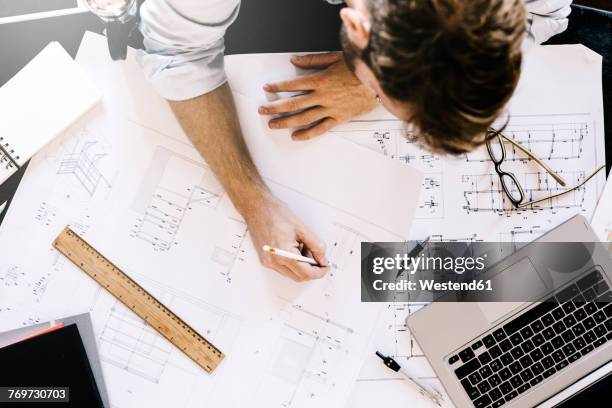 man working on construction plan at desk, top view - architecture blueprint stock pictures, royalty-free photos & images