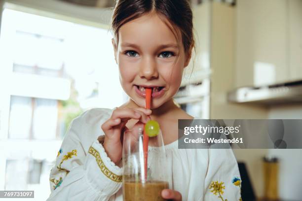 girl enjoying her homemade smoothie - drinking straw stock-fotos und bilder