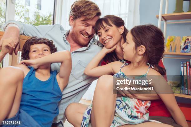 happy family in children's room - family with two children stock-fotos und bilder