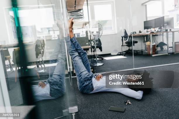 young woman having a break in office - businesswoman barefoot stock-fotos und bilder