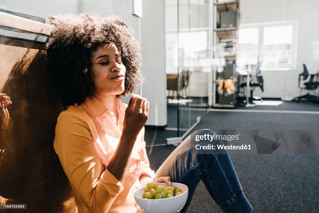 Young woman having a break in office