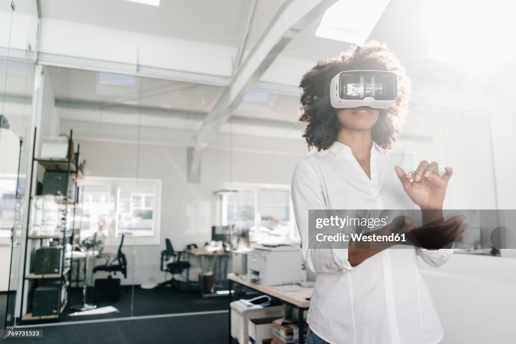 Woman wearing VR glasses in office