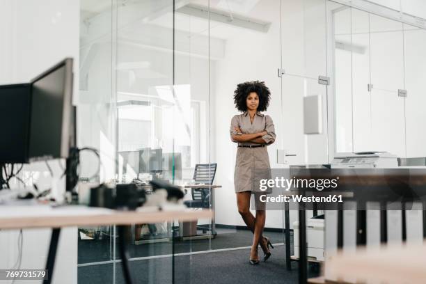 portrait of confident businesswoman in office - business woman standing office stock-fotos und bilder