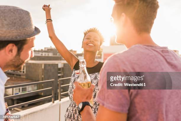 friends having a rooftop party - rooftop party stock pictures, royalty-free photos & images