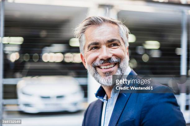 portrait of smiling businessman - business man car stock-fotos und bilder