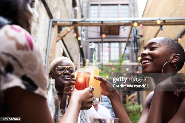 three friends toasting with cocktails - adult summer stock pictures, royalty-free photos & images