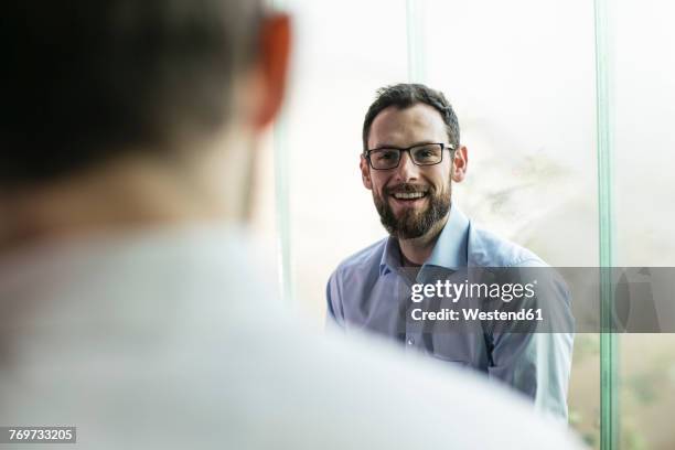 two businessmen having a meeting in office - 2017 review stock-fotos und bilder