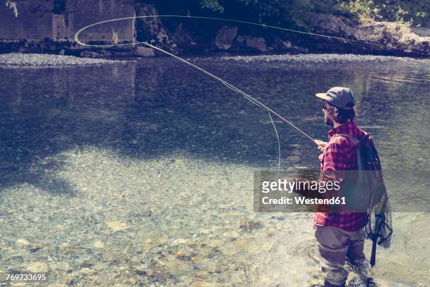 slovenia, man fly fishing in soca river - slovenia soca stock pictures, royalty-free photos & images
