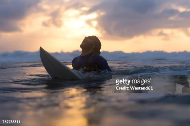 indonesia, bali, surfer in the ocean at sunrise - this morning 2017 ストックフォトと画像