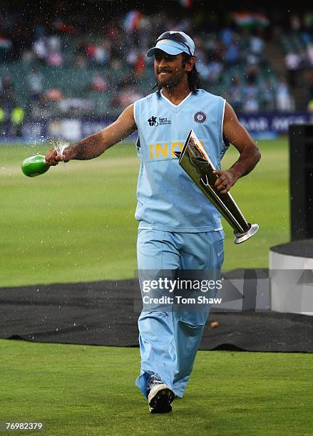 Indian Captain Mahendra Singh Dhoni celebrates with the trophy during the Twenty20 Championship Final match between Pakistan and India at The...