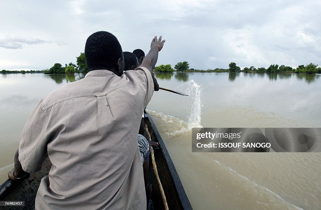 Family members paddle a canoe across the