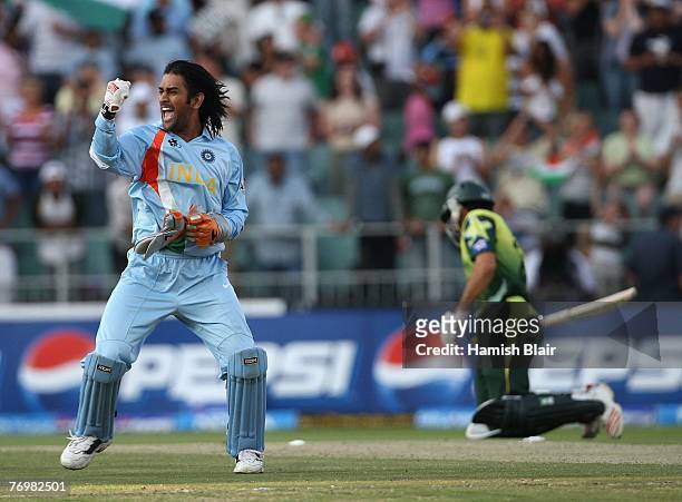 Dhoni of India celebrates his team's victory with Misbah-ul-Haq of Pakistan looking on during the Twenty20 Championship Final match between Pakistan...