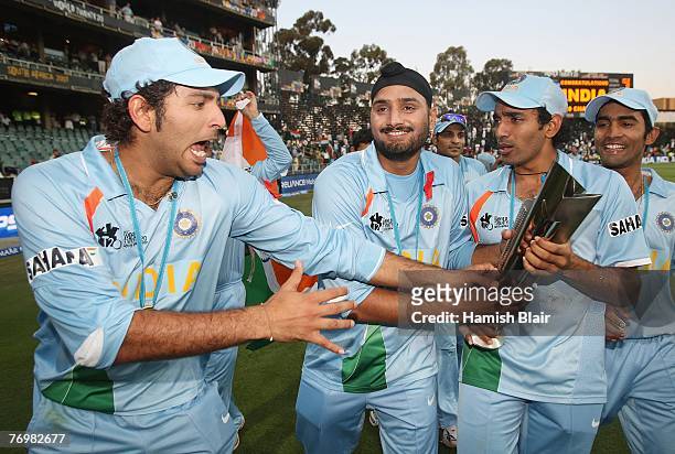 Yuvraj Singh, Harbhajan Singh and Robin Uthappa of India celebrate with the trophy after the Twenty20 Championship Final match between Pakistan and...