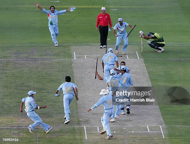 The Indian Team celebrate their win with Misbah-ul-Haq looking on after the Twenty20 Championship Final match between Pakistan and India at The...