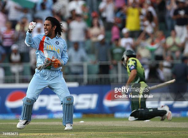 Dhoni of India celebrates his team's victory with Misbah-ul-Haq of Pakistan looking on during the Twenty20 Championship Final match between Pakistan...