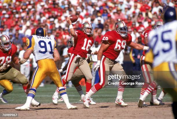 Quarterback Joe Montana of the San Francisco 49ers passes behind the protection of guard Bruce Collie against Los Angeles Rams linebacker Kevin...