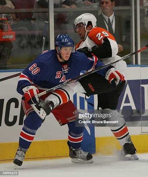 Lauri Korpikoski of the New York Rangers hits Nate Guenin of the Philadelphia Flyers during preseason action on September 22, 2007 at Madison Square...