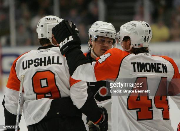 Scottie Upshall, Sami Kapanen and Kimmo Timonen of the Philadelphia Flyers celebrate a goal against the New York Rangers during preseason action on...