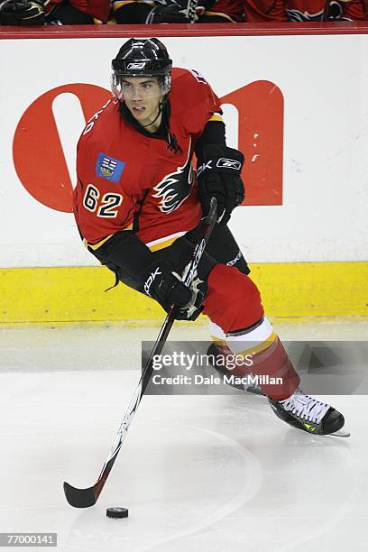 Kris Chucko of the Calgary Flames skates with the puck against the Florida Panthers at the Pengrowth Saddledome on September 16, 2007 in Calgary,...