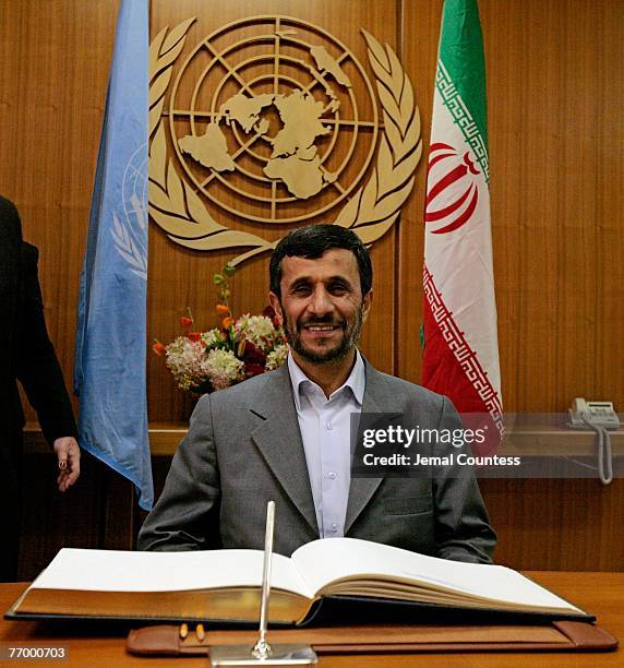 Iranian President Mahmoud Ahmadinejad sits in front of the Secretary Generals register during his meeting with United Nations Secretary-General Ban...