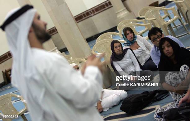 Mohammed Raisi , a volunteer with the Sheikh Mohammed Centre for Cultural Understanding, explains the fundamentals of Islam to a group of tourists...