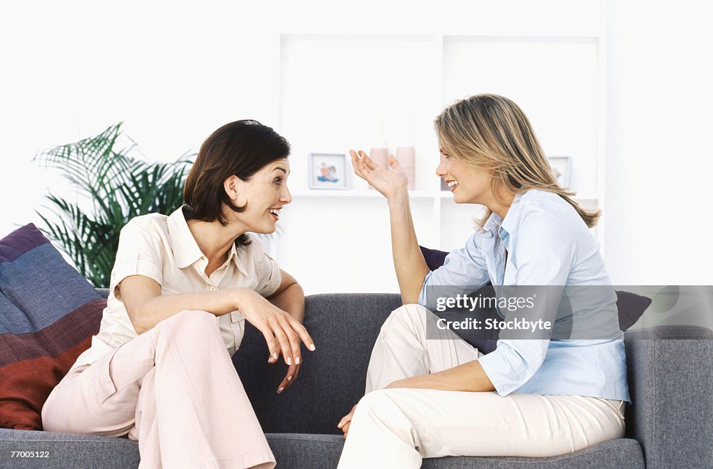 Two women talking in living room