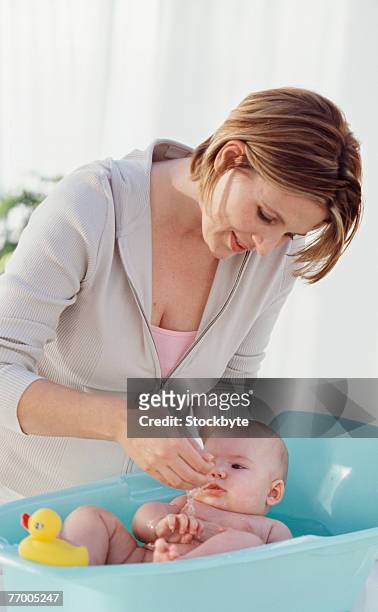 mother playing with baby (6-12 months) indoors - baby bath toys stock pictures, royalty-free photos & images