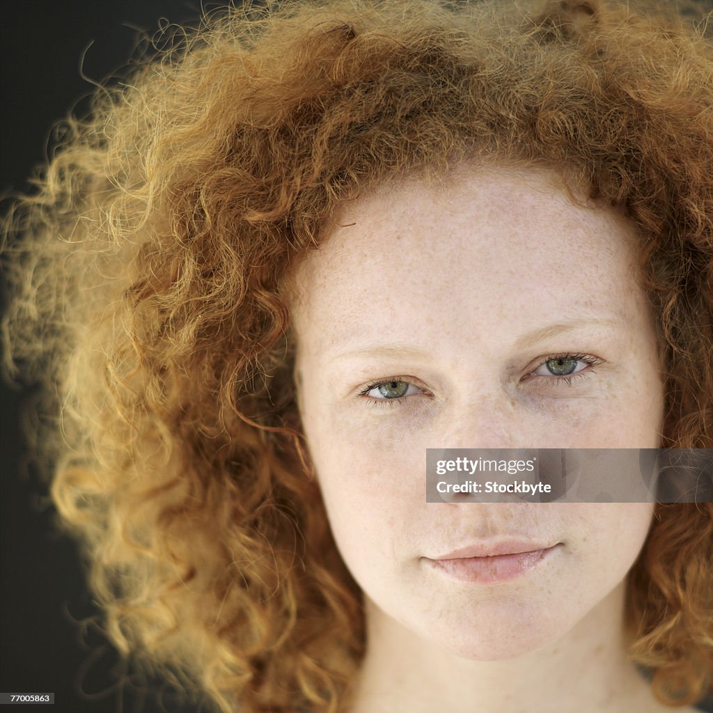 Young woman with red curly hair, portrait, close-up