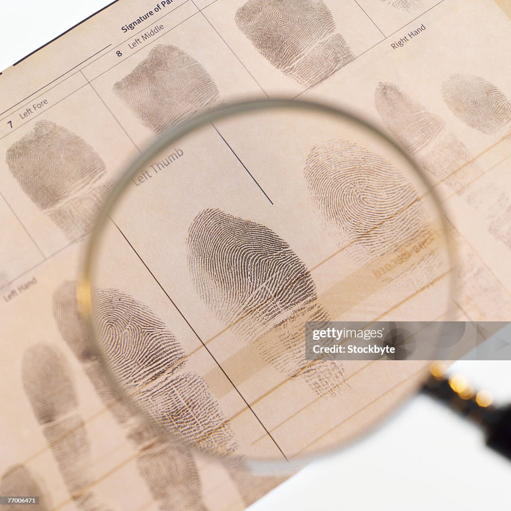 Magnifying glass on fingerprints on chart