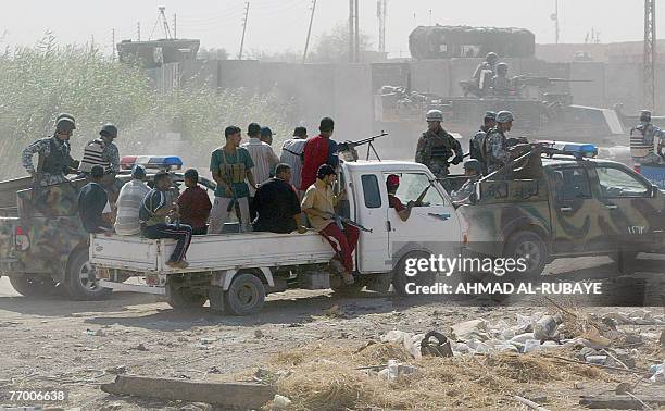 Former Iraqi insurgents members of the Sunni Anbar Awakening , Iraqi police commandos "Wolves" and US troops , guard a meeting between Sunni and...