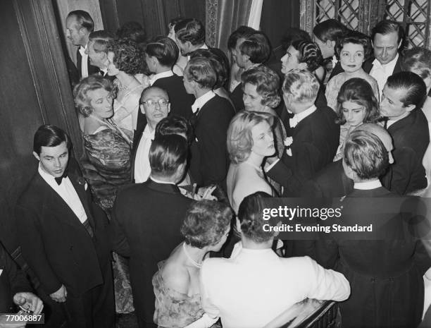 Party at Sutton Place, the Surrey home of American oil tycoon J. Paul Getty, 1st July 1960. The guests queue up to enter the dining room.